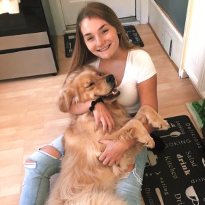 photo of Asia Rivett with a golden retriever